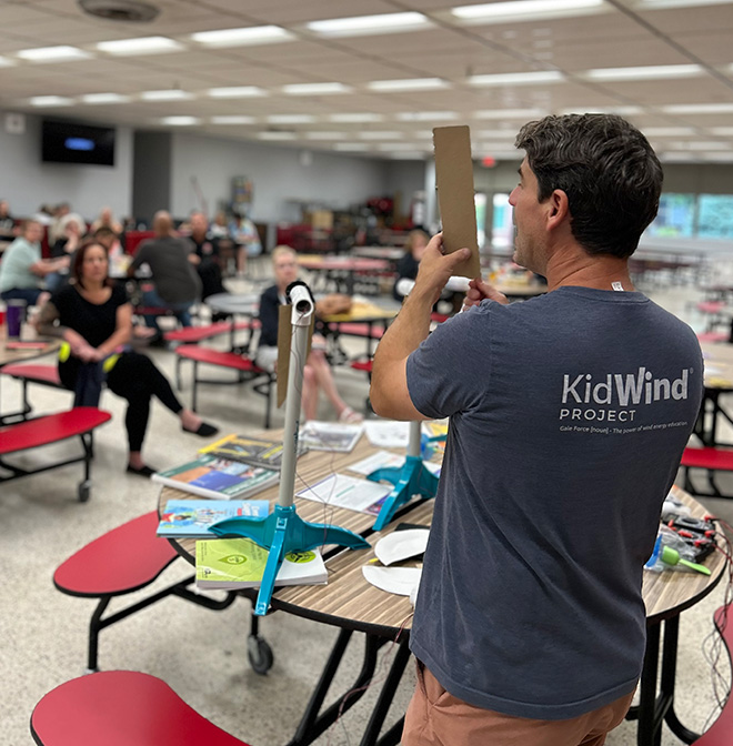 KidWind instructor stands in front of students teaching them about renewable energy